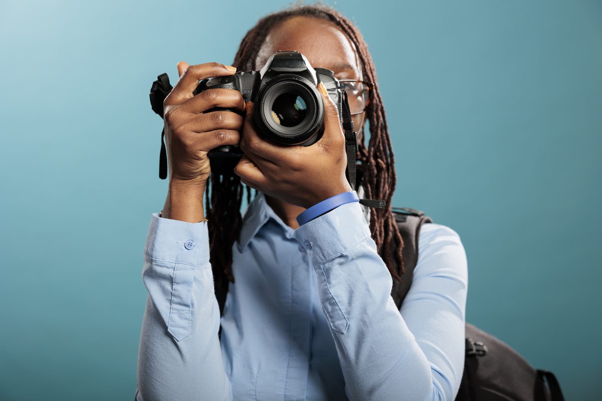 Photographer holding a camera ready to shoot